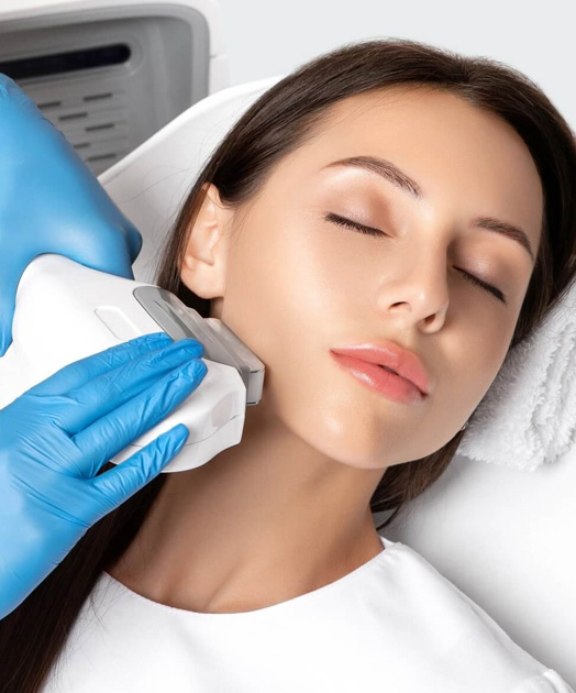 Patient relaxing during a facial skin treatment at Pure Derma Clinic